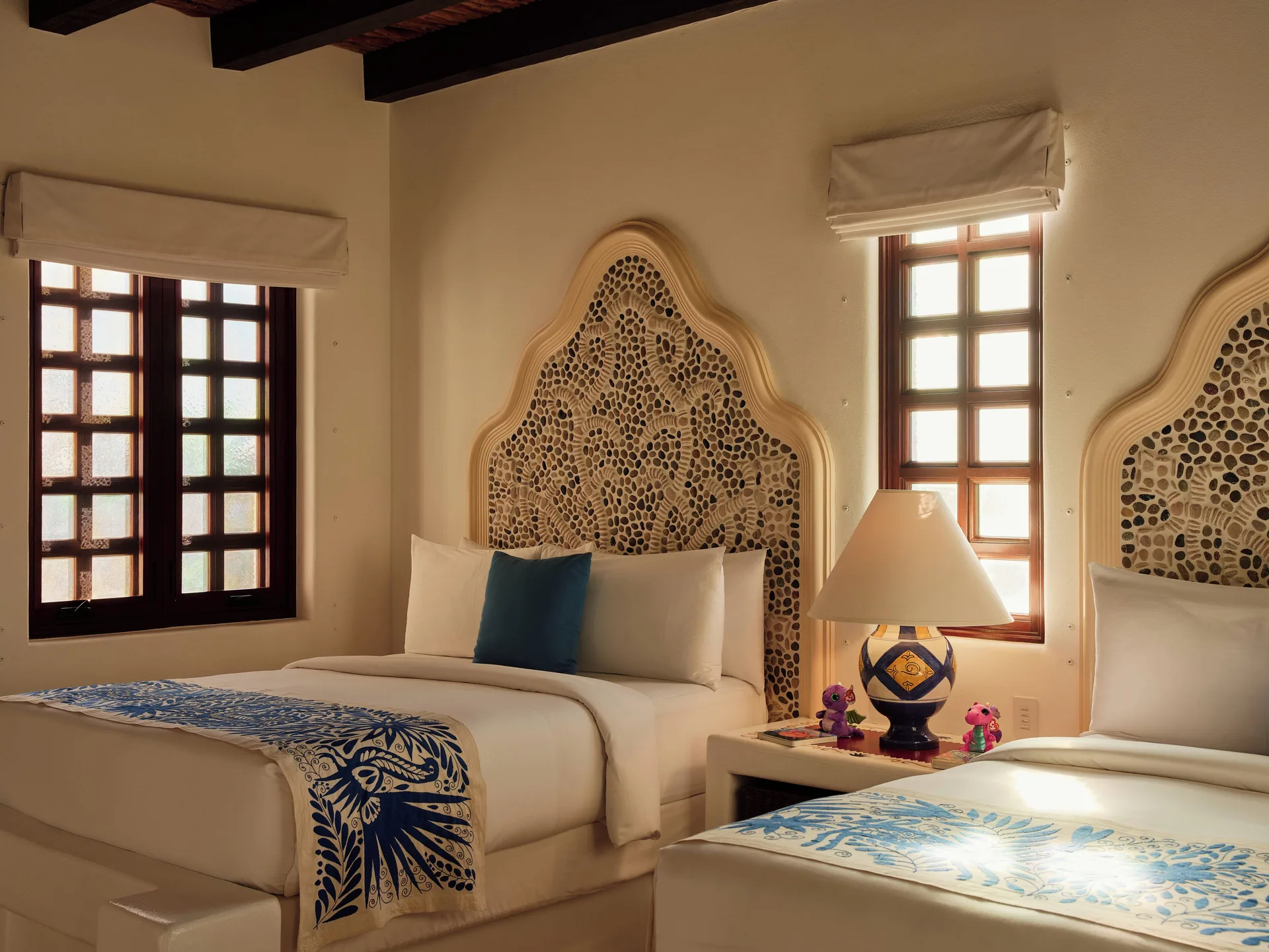 Two beds with mosaic headboards in a residence bedroom at Las Ventanas al Paraiso.
