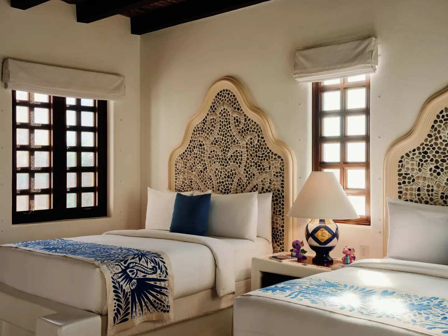 Two beds with mosaic headboards in a villa bedroom at Las Ventanas al Paraiso.
