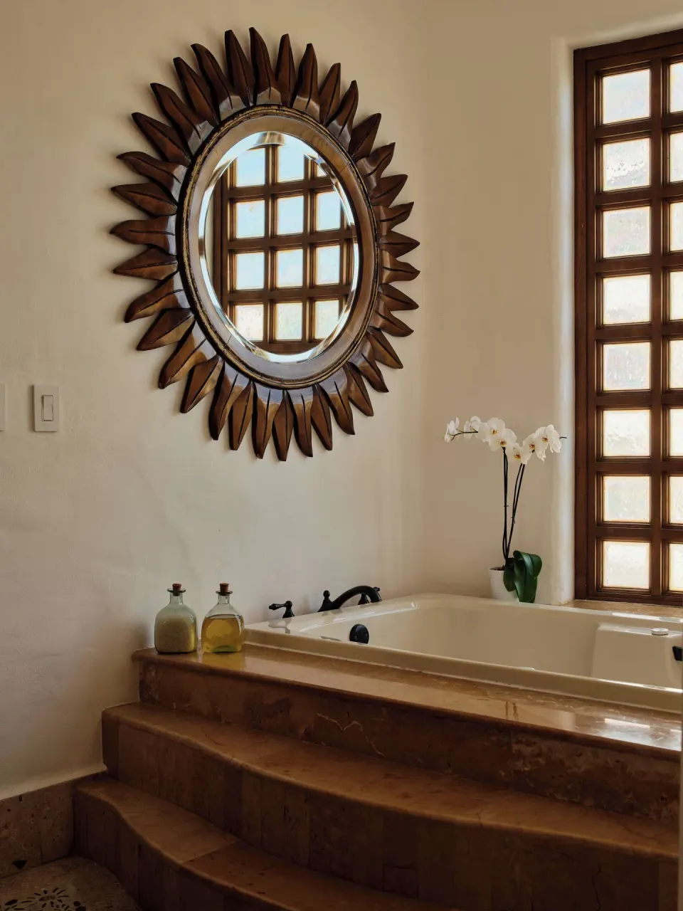 Bathroom tub and sunburst mirror in Two Bedroom Oceanview Penthouse Residence at Las Ventanas al Paraiso.