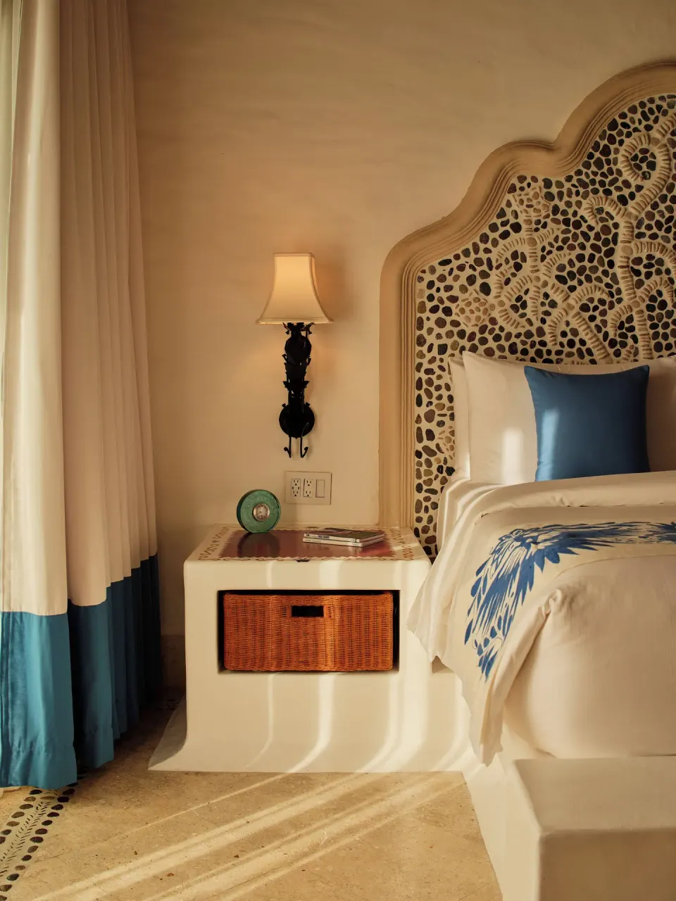 Bedside table and patterned headboard in Two Bedroom Oceanview Penthouse Residence at Las Ventanas al Paraiso.