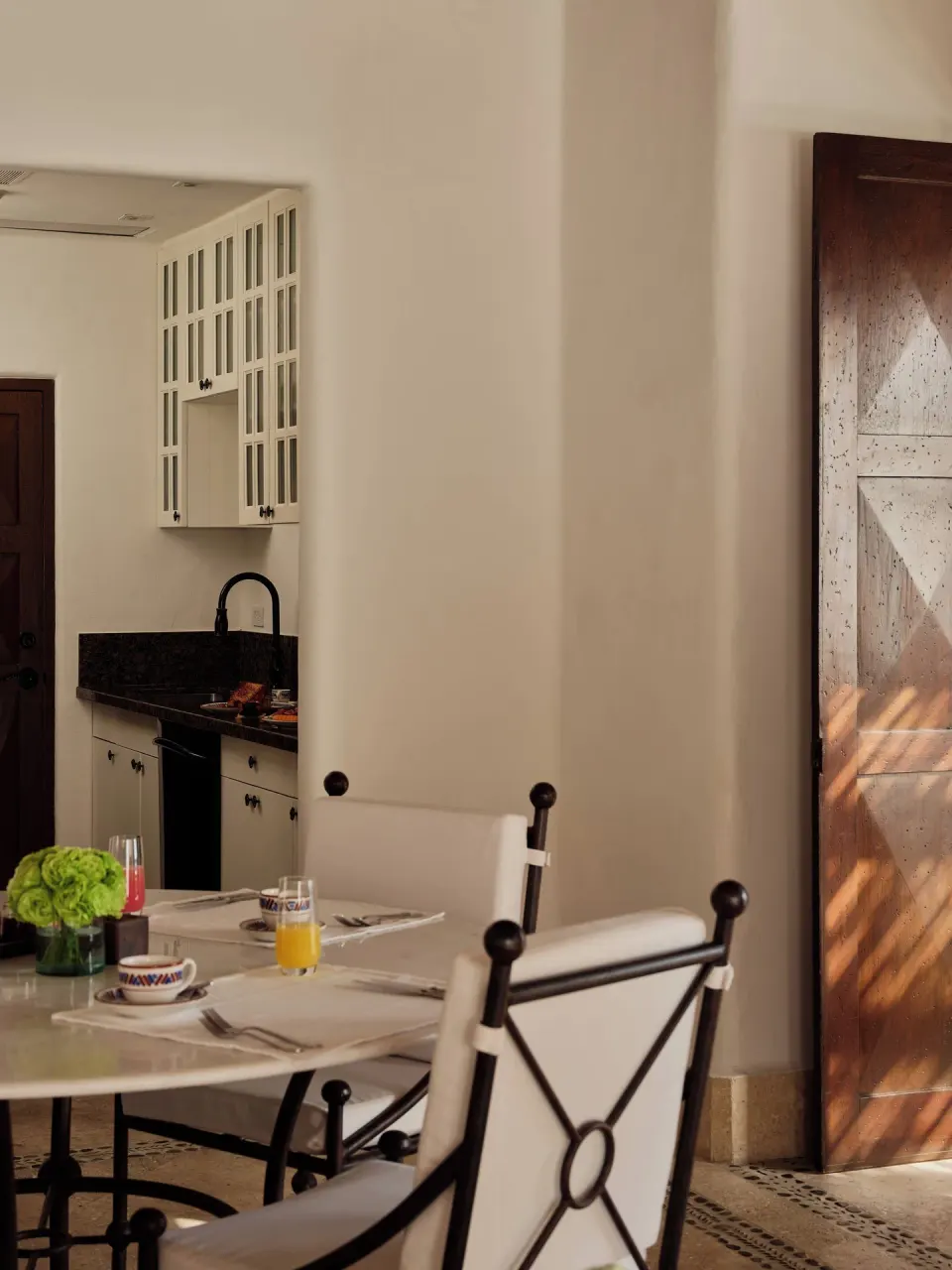 Dining table and kitchenette in Two Bedroom Oceanview Penthouse Residence at Las Ventanas al Paraiso.