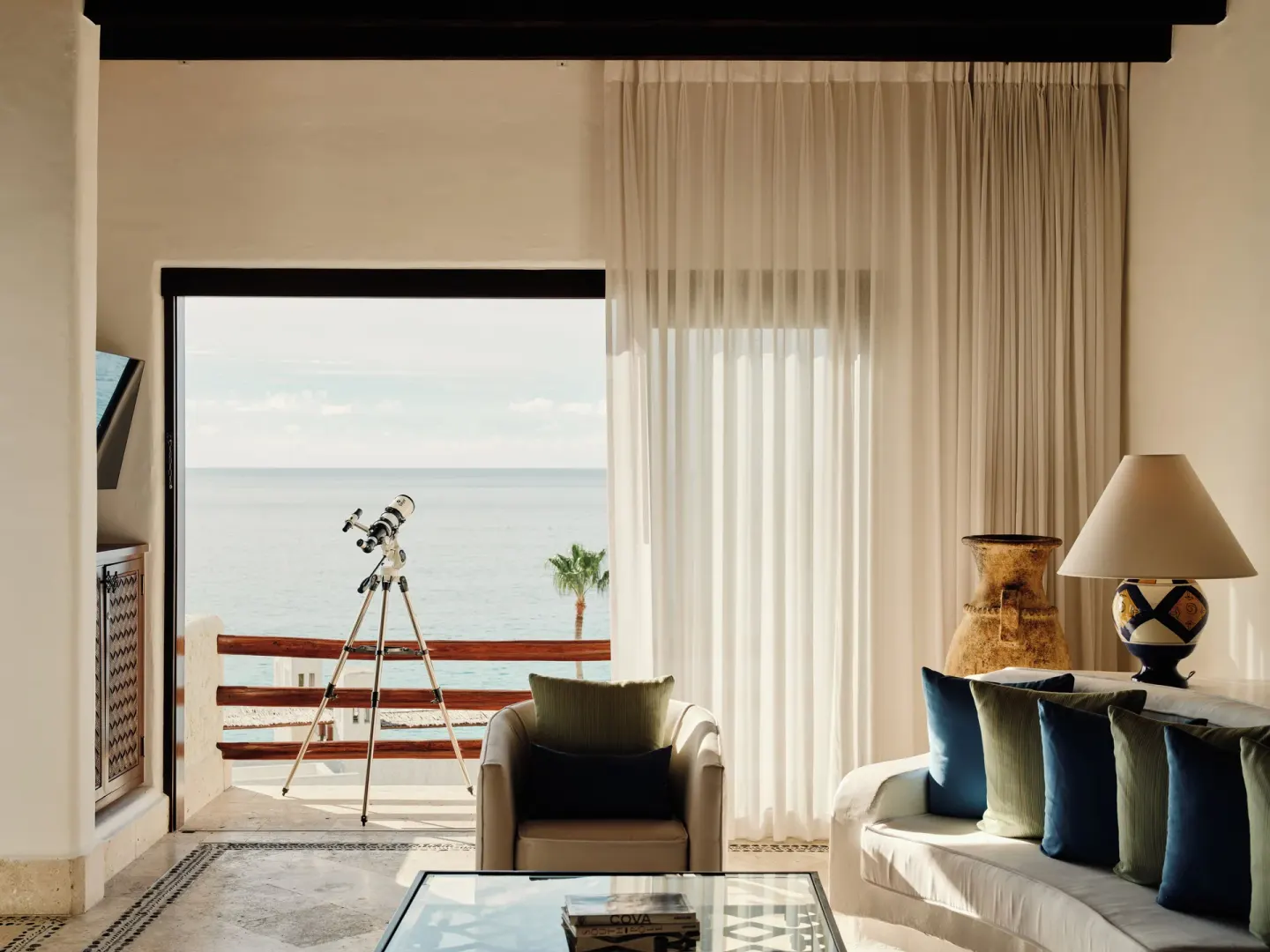 Oceanview living room with balcony telescope at Las Ventanas al Paraiso.