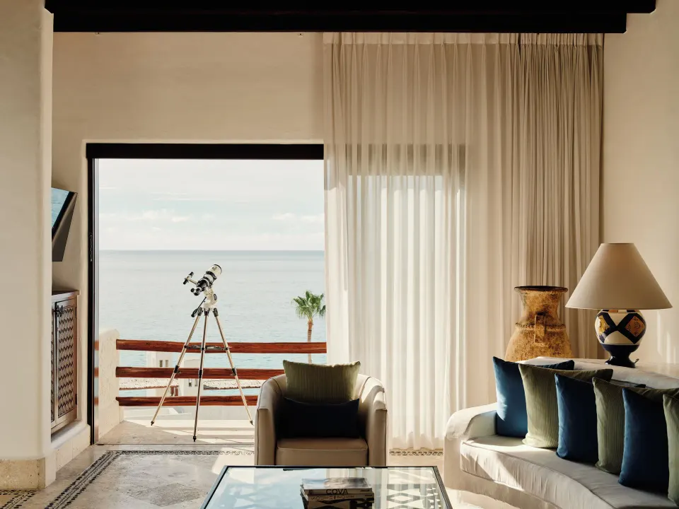Oceanview living room with balcony telescope at Las Ventanas al Paraiso.