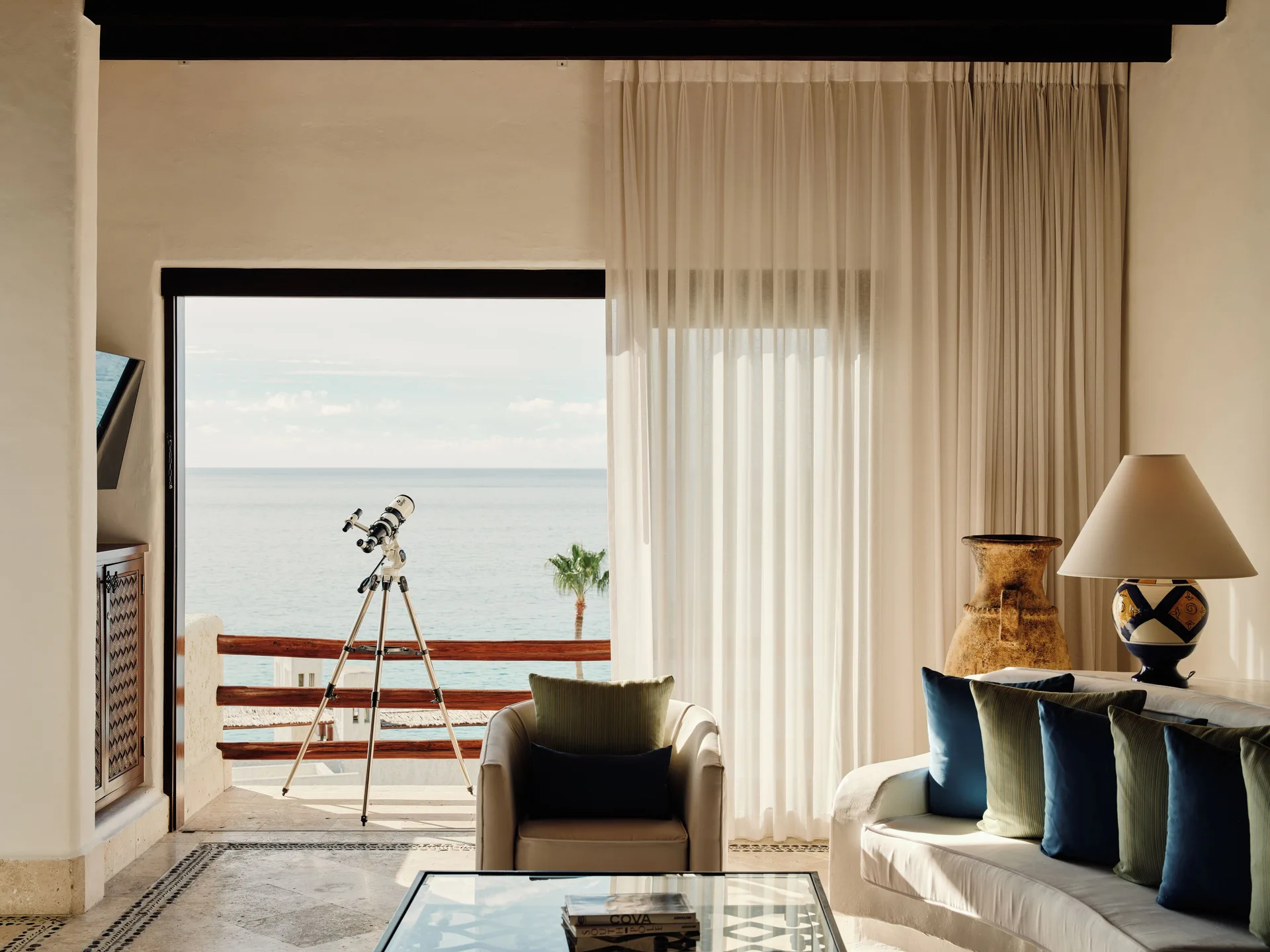 Oceanview living room with balcony telescope at Las Ventanas al Paraiso.