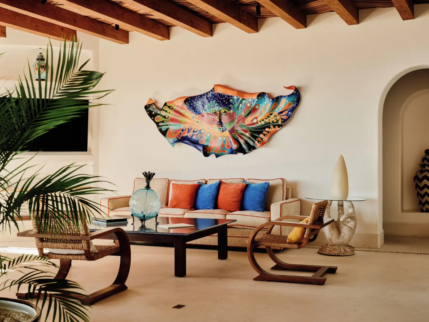 Living room with colorful wall art in Two Bedroom Oceanview Penthouse Residence at Las Ventanas al Paraiso.