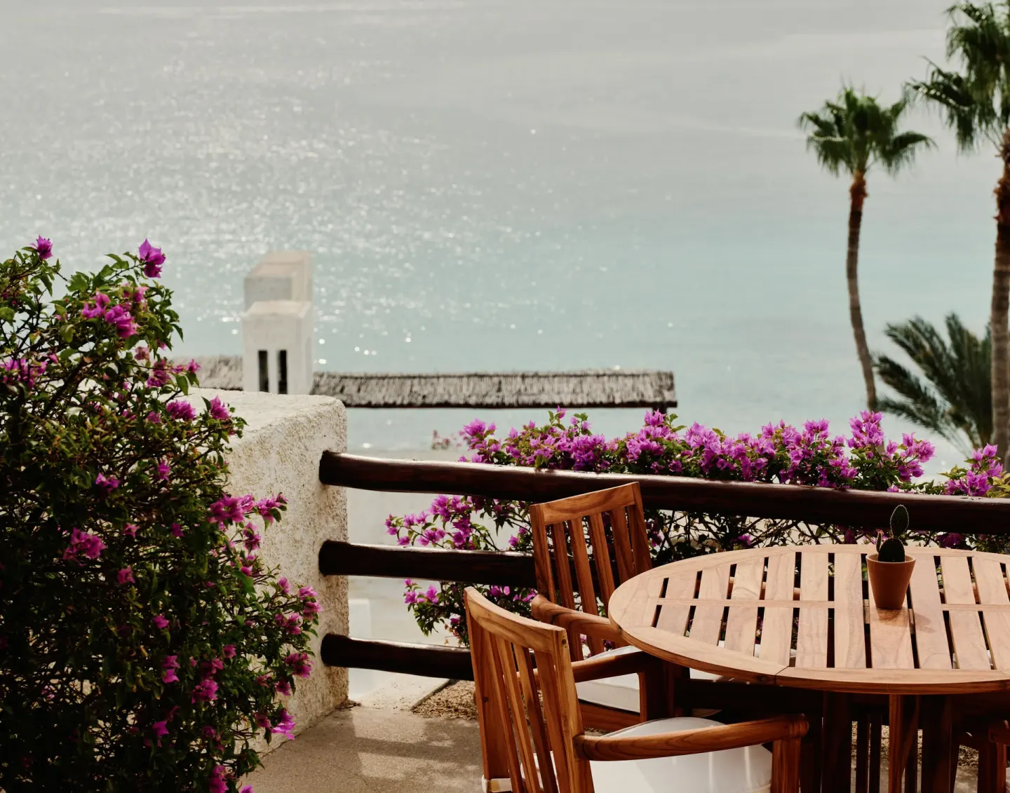 Oceanview terrace dining table with bougainvillea at Las Ventanas al Paraiso.