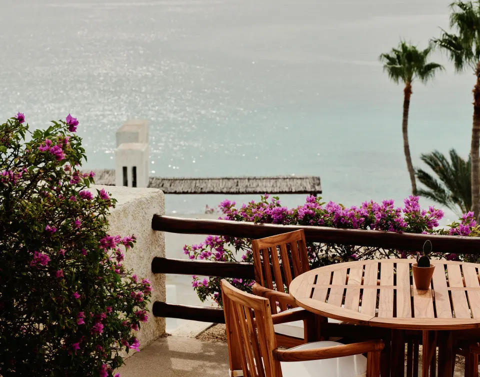 Oceanview terrace dining table with bougainvillea at Las Ventanas al Paraiso.