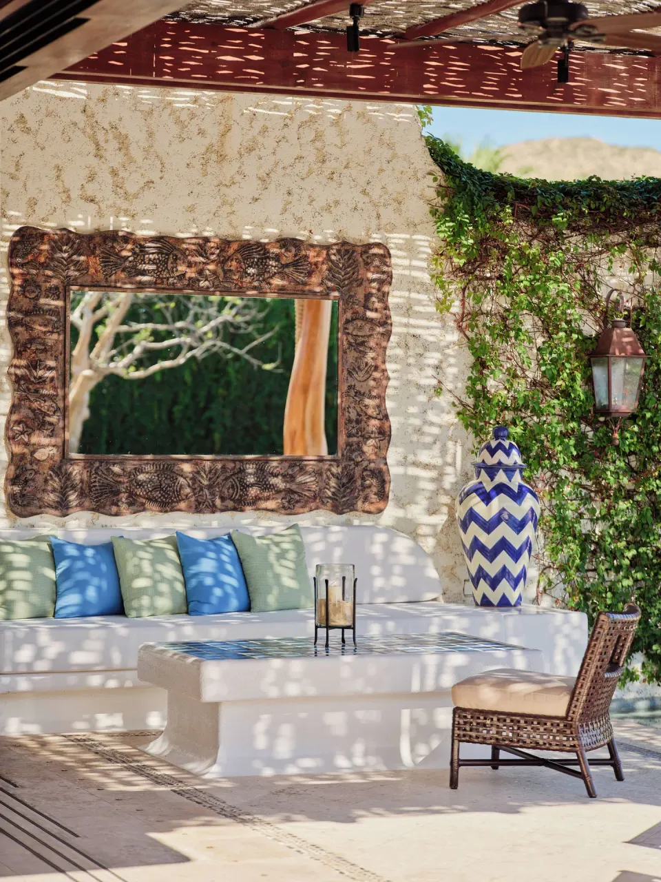 Shaded villa patio seating with mirror and blue ceramic vase at Las Ventanas al Paraiso.