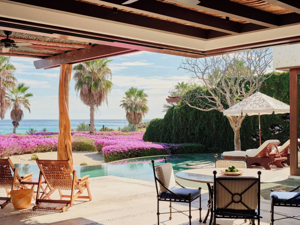 Oceanview villa terrace with pool, loungers and flowering gardens at Las Ventanas al Paraiso.