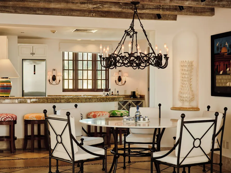 Dining table and kitchen in the Two Bedroom Ty Warner Penthouse at Las Ventanas al Paraiso.