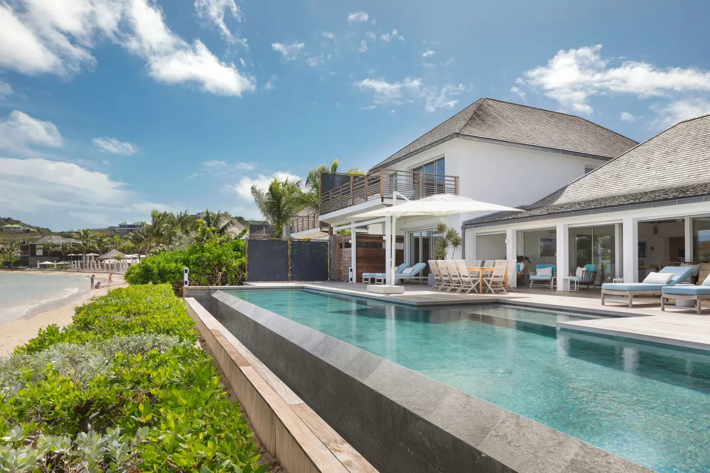 Beachfront pool and villa-style building at Le Barthélemy Hotel & Spa.