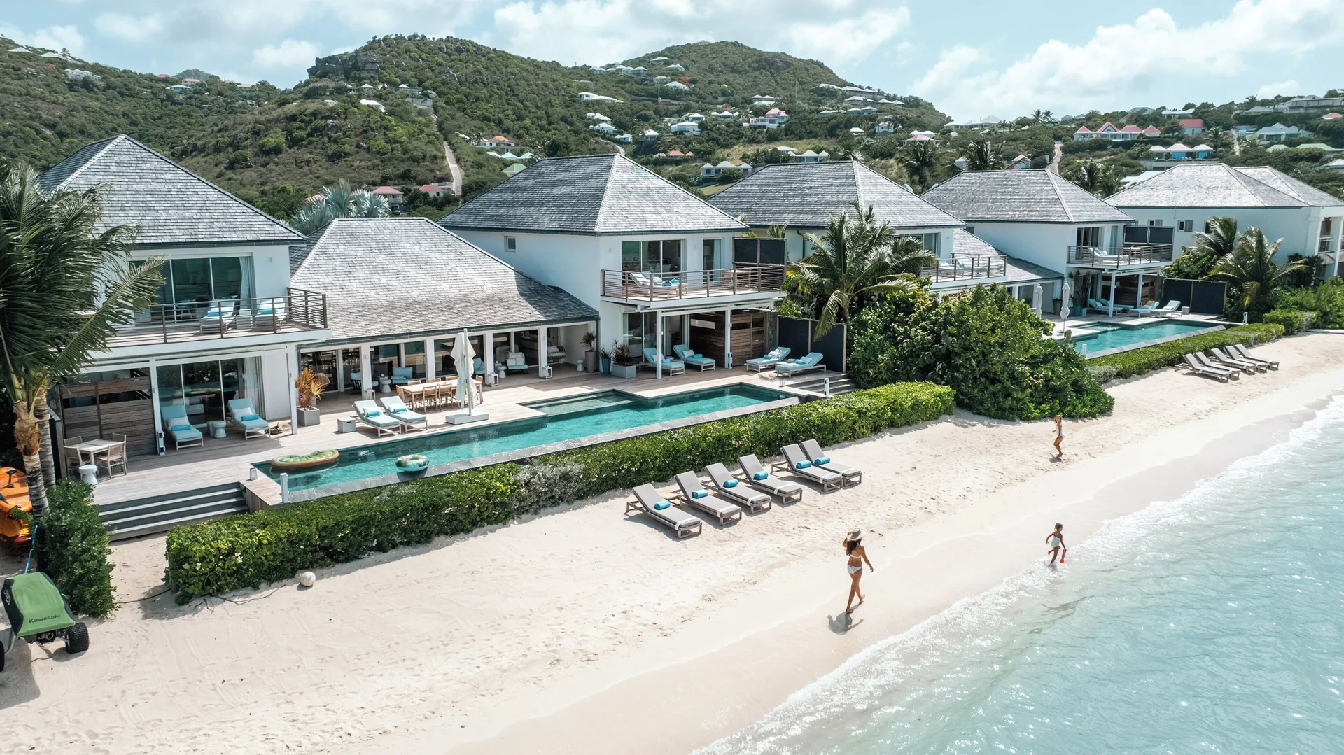 Beachfront villas with pools, loungers, and white sand at Le Barthélemy Hotel & Spa.