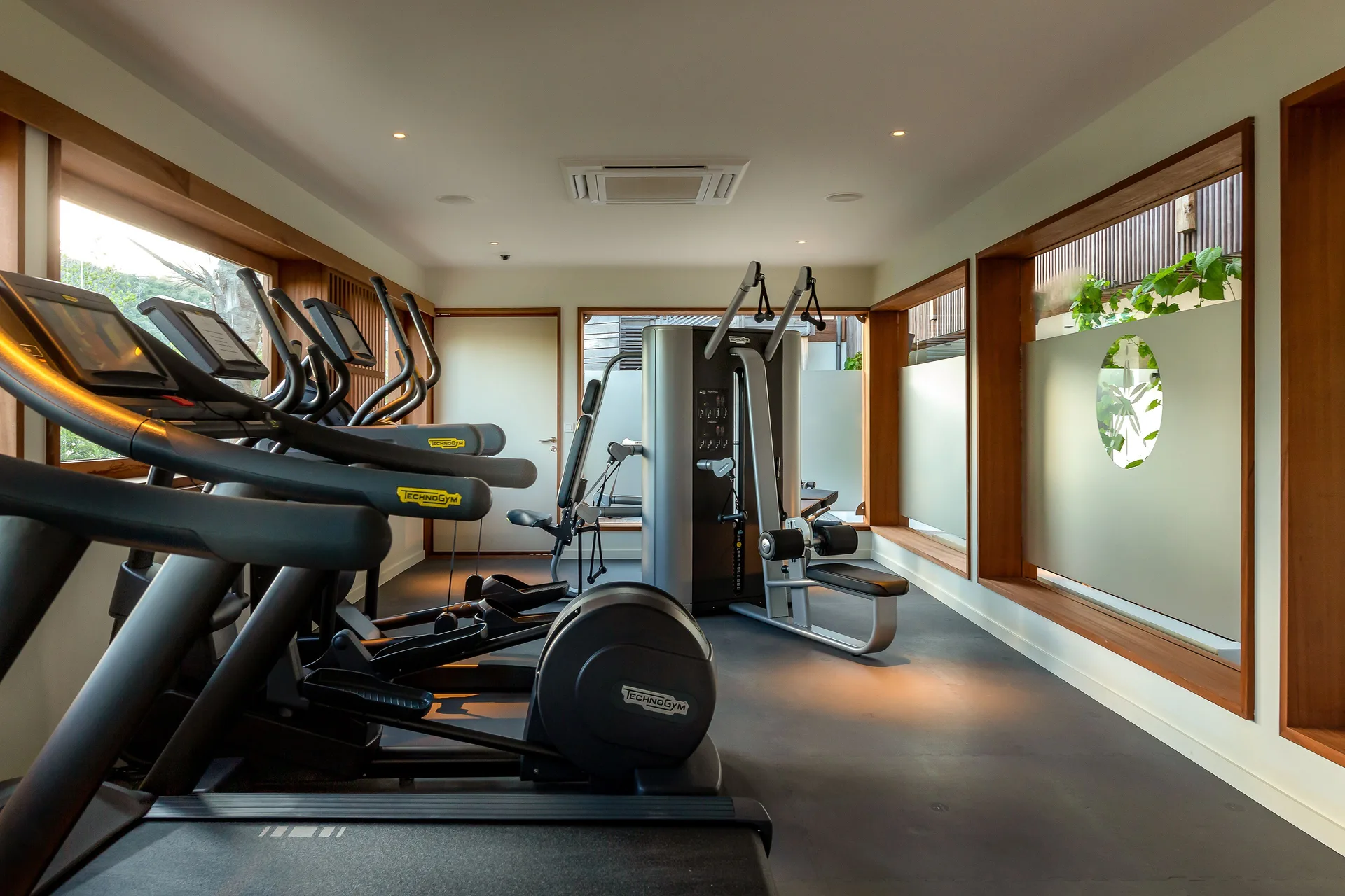 Fitness room with cardio machines and strength equipment at Le Barthélemy Hotel & Spa.