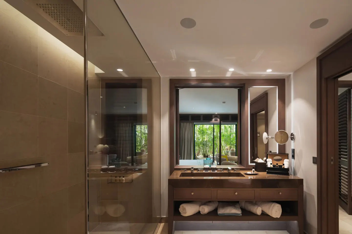 Bathroom vanity and glass shower in a guest suite at Le Barthélemy Hotel & Spa.