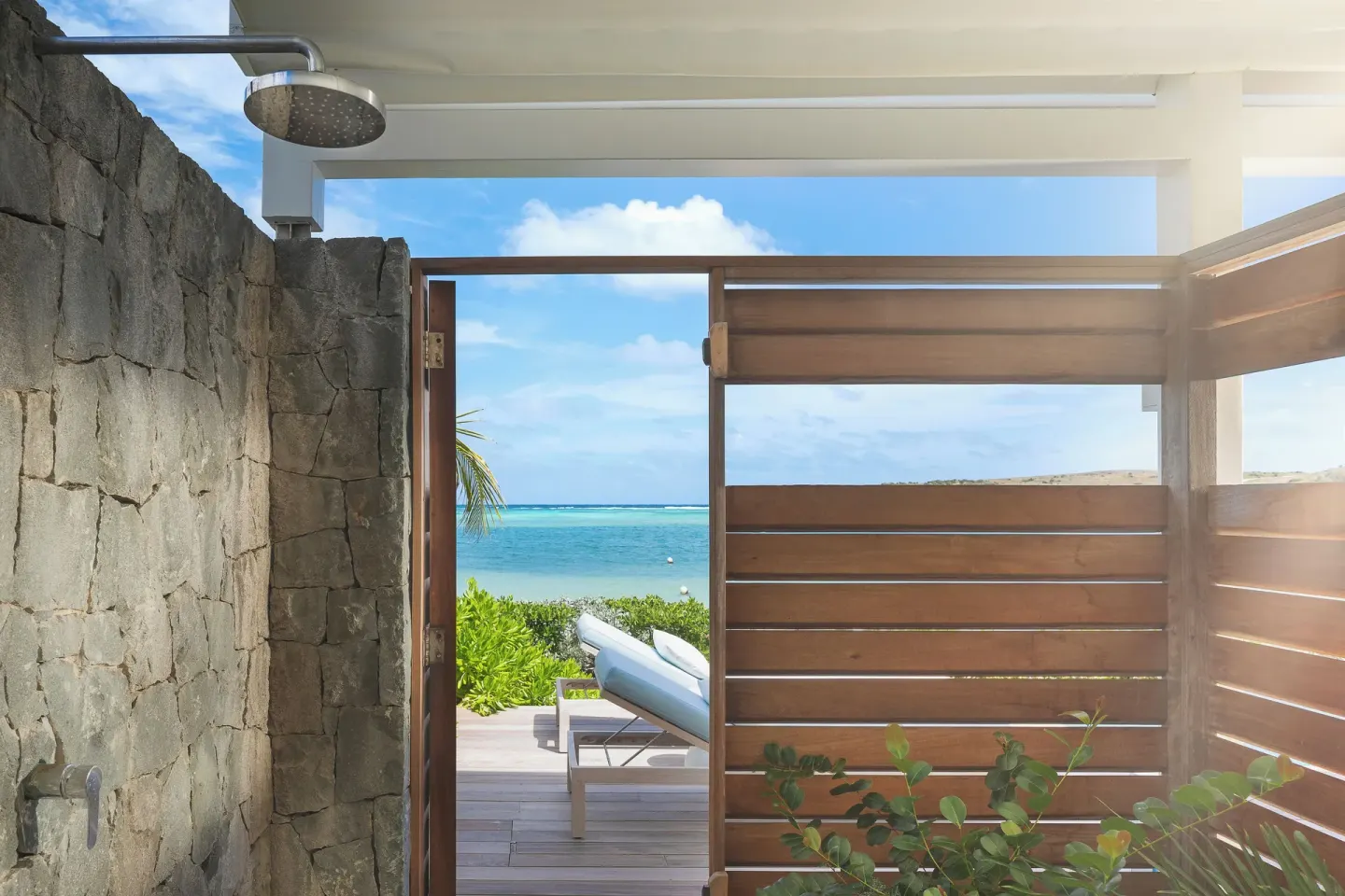 Outdoor shower with ocean view and private deck at Le Barthélemy Hotel & Spa.