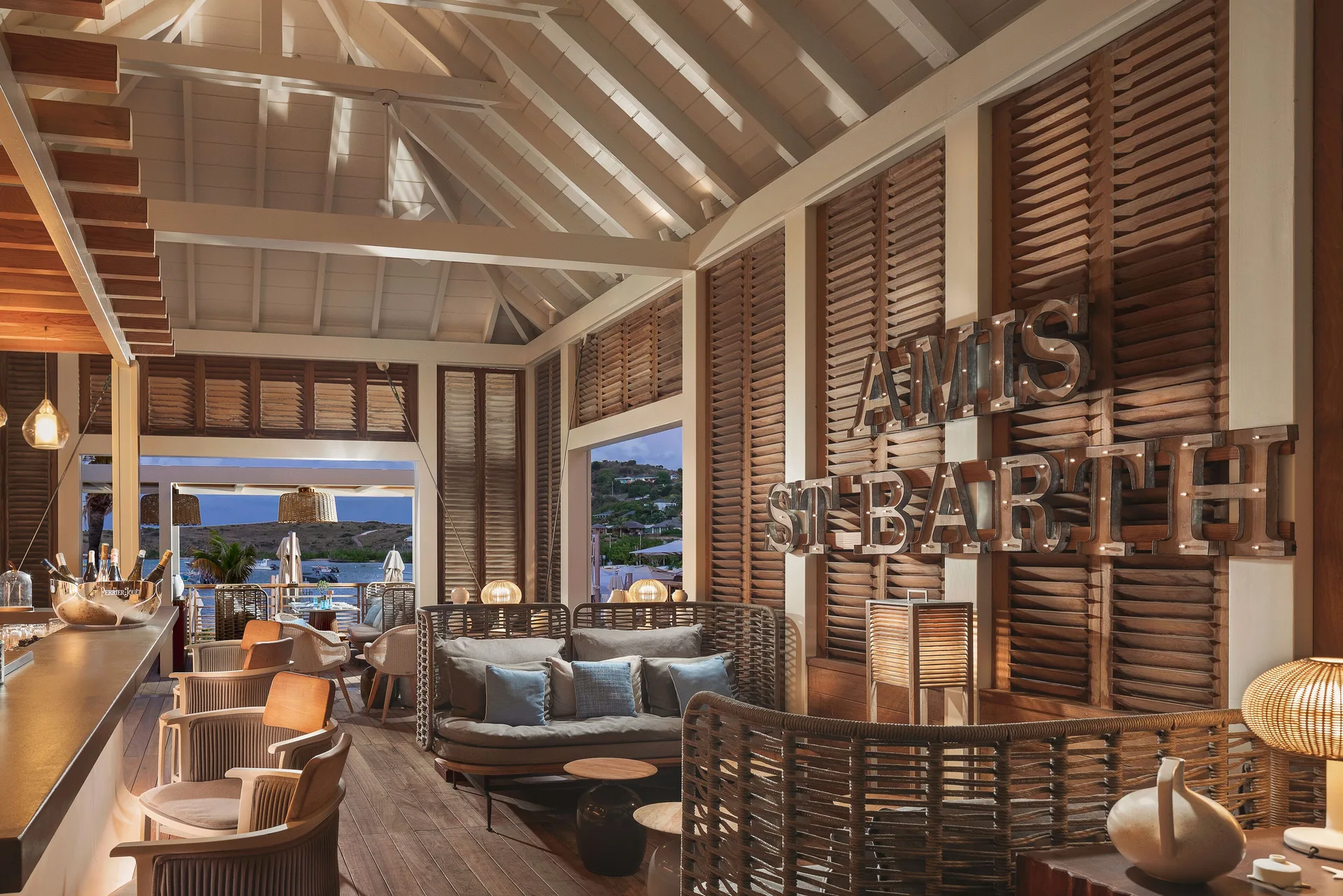 Seven Stars Bar lounge with signage and ocean view at Le Barthélemy Hotel & Spa.
