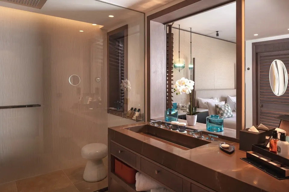 Bathroom vanity and shower in La Suite Océan Piscine Privée at Le Barthélemy Hotel & Spa.