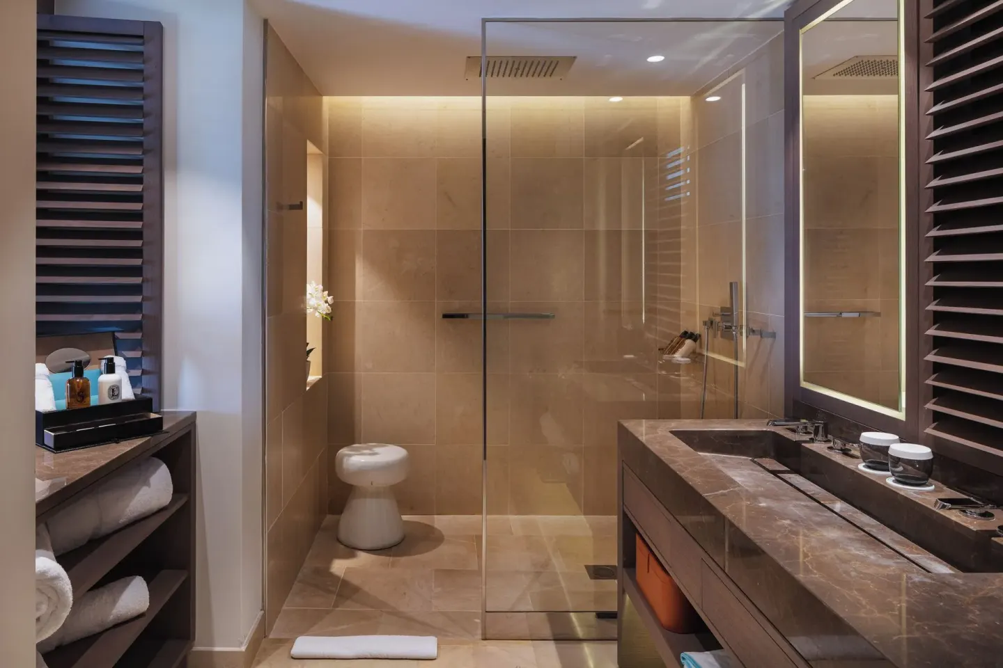 Ocean Signature Suite bathroom with glass shower and vanity at Le Barthélemy Hotel & Spa.