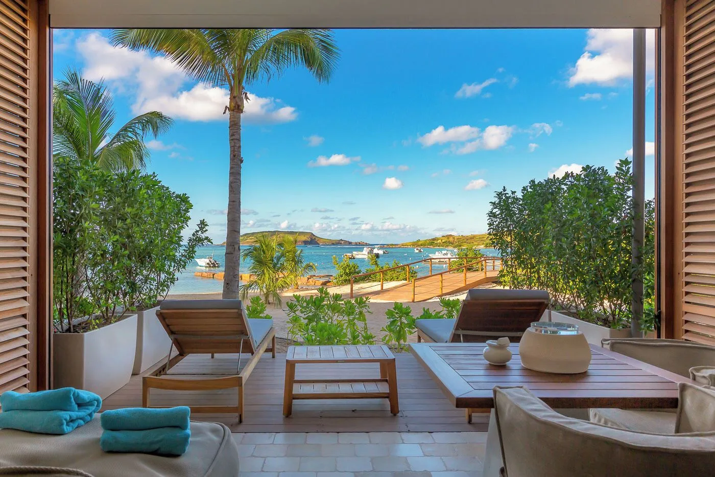Ocean Signature Suite terrace with loungers facing the bay at Le Barthélemy Hotel & Spa.