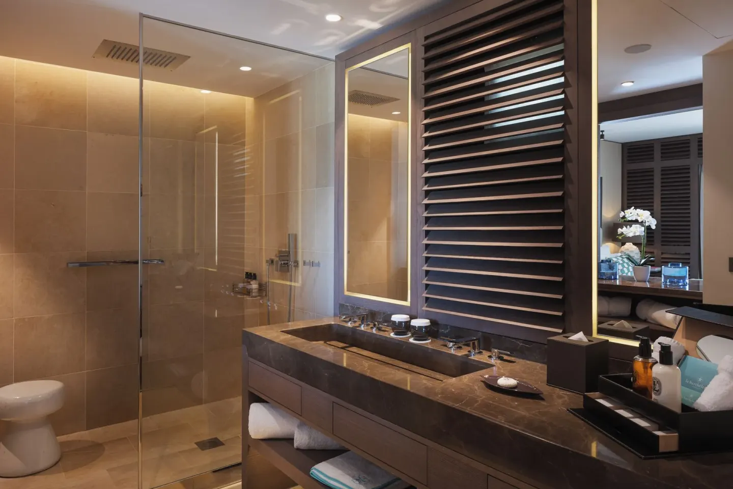 La Suite Signature Plage bathroom with vanity and glass shower at Le Barthélemy Hotel & Spa.