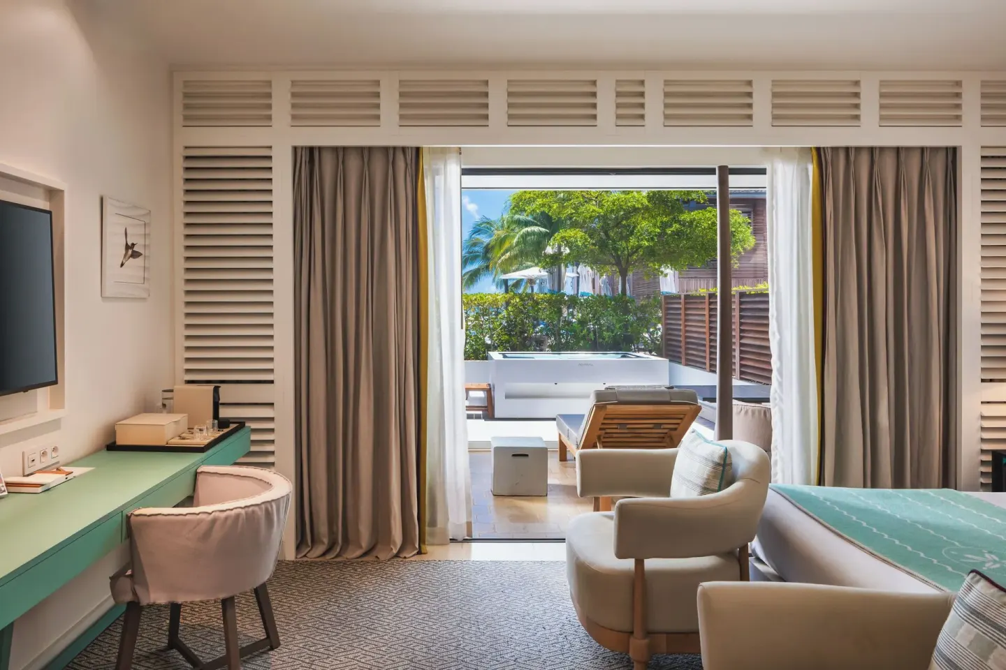 Le Barth Océan Jacuzzi room at Le Barthélemy Hotel & Spa with terrace, desk, seating, and partial bed view.