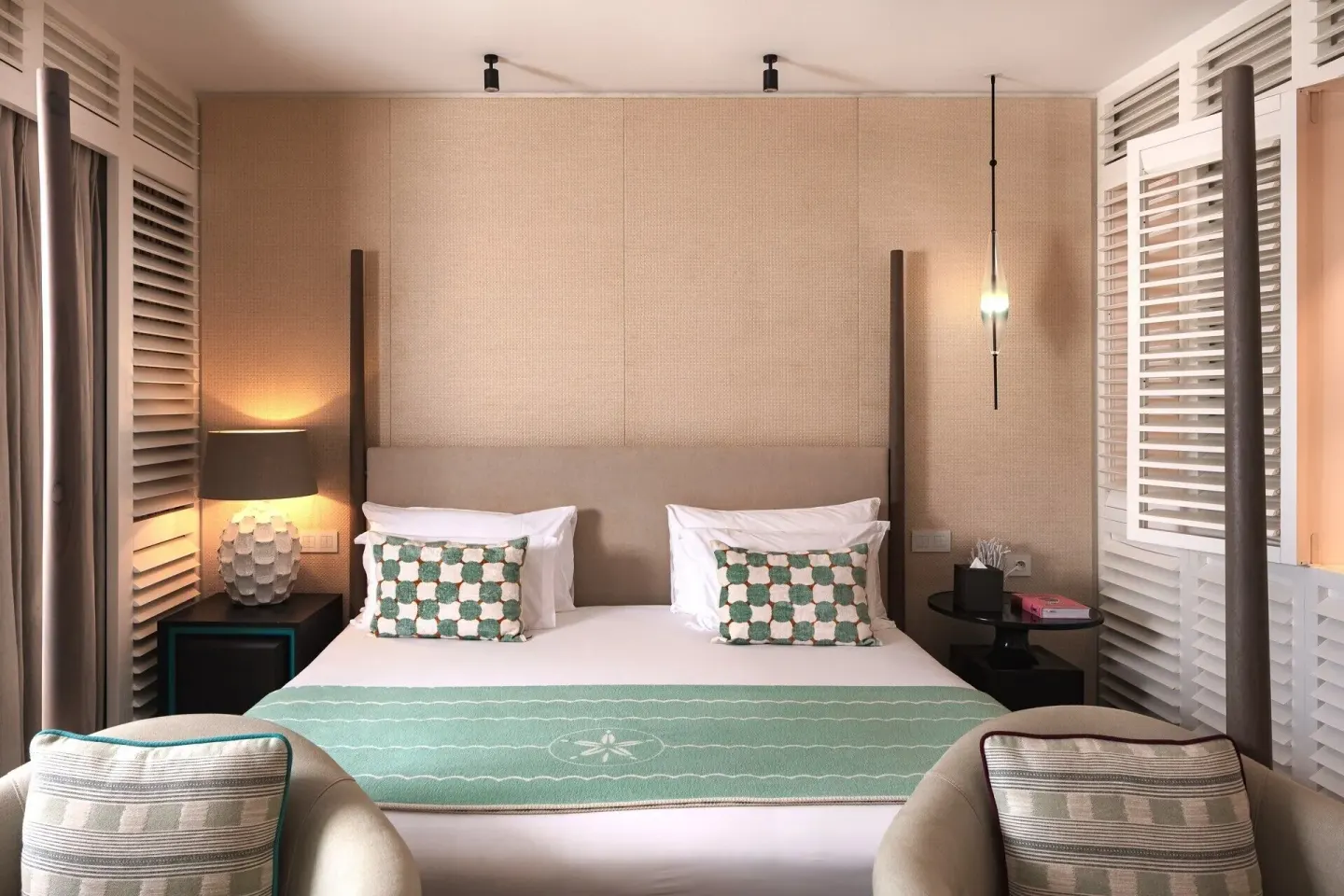 Le Barth Océan Jacuzzi room king bed at Le Barthélemy Hotel & Spa with turquoise accents and louvered shutters.