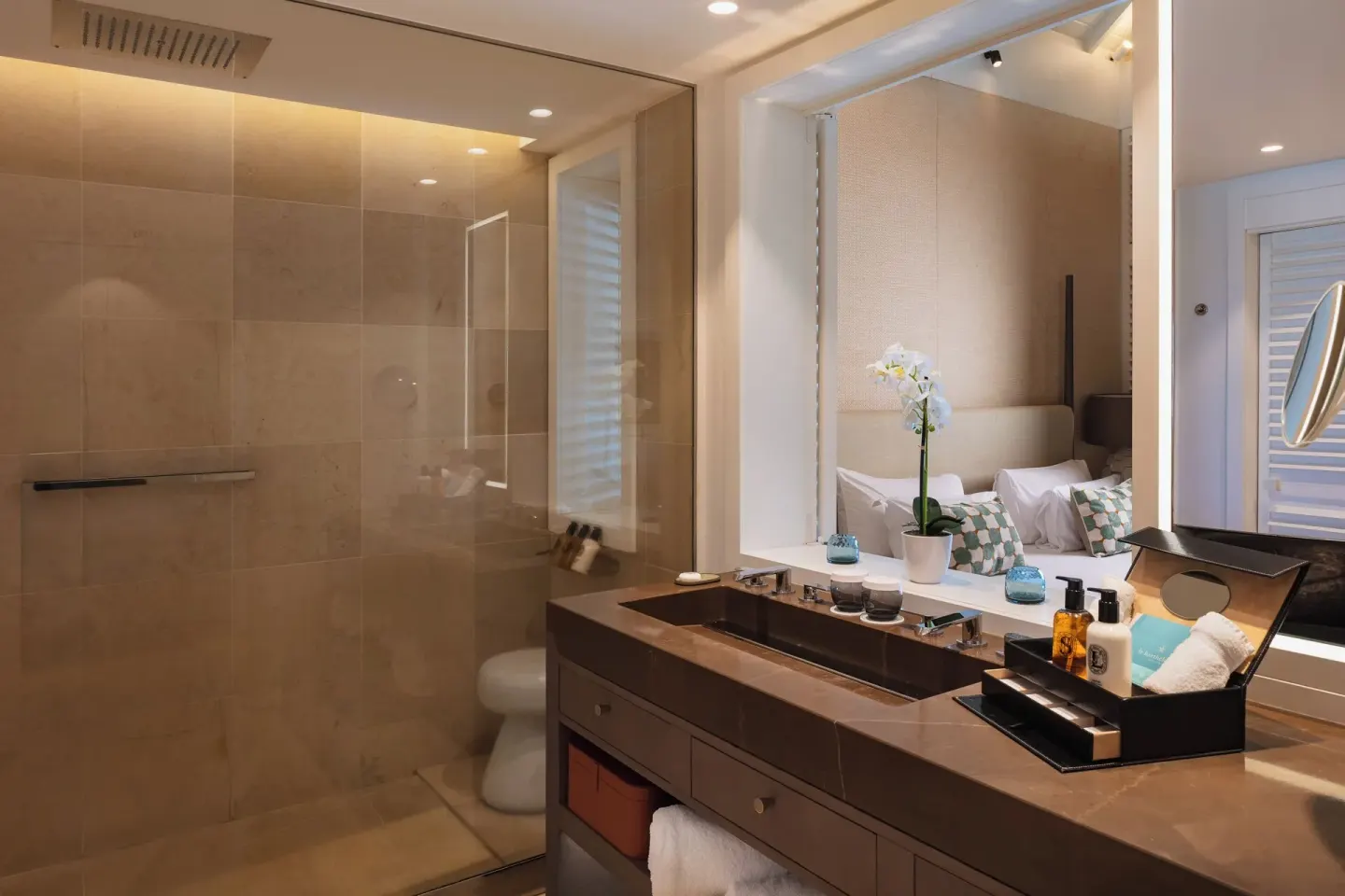 Bathroom vanity and glass shower in Le Barth Océan Vue Mer at Le Barthélemy Hotel & Spa.
