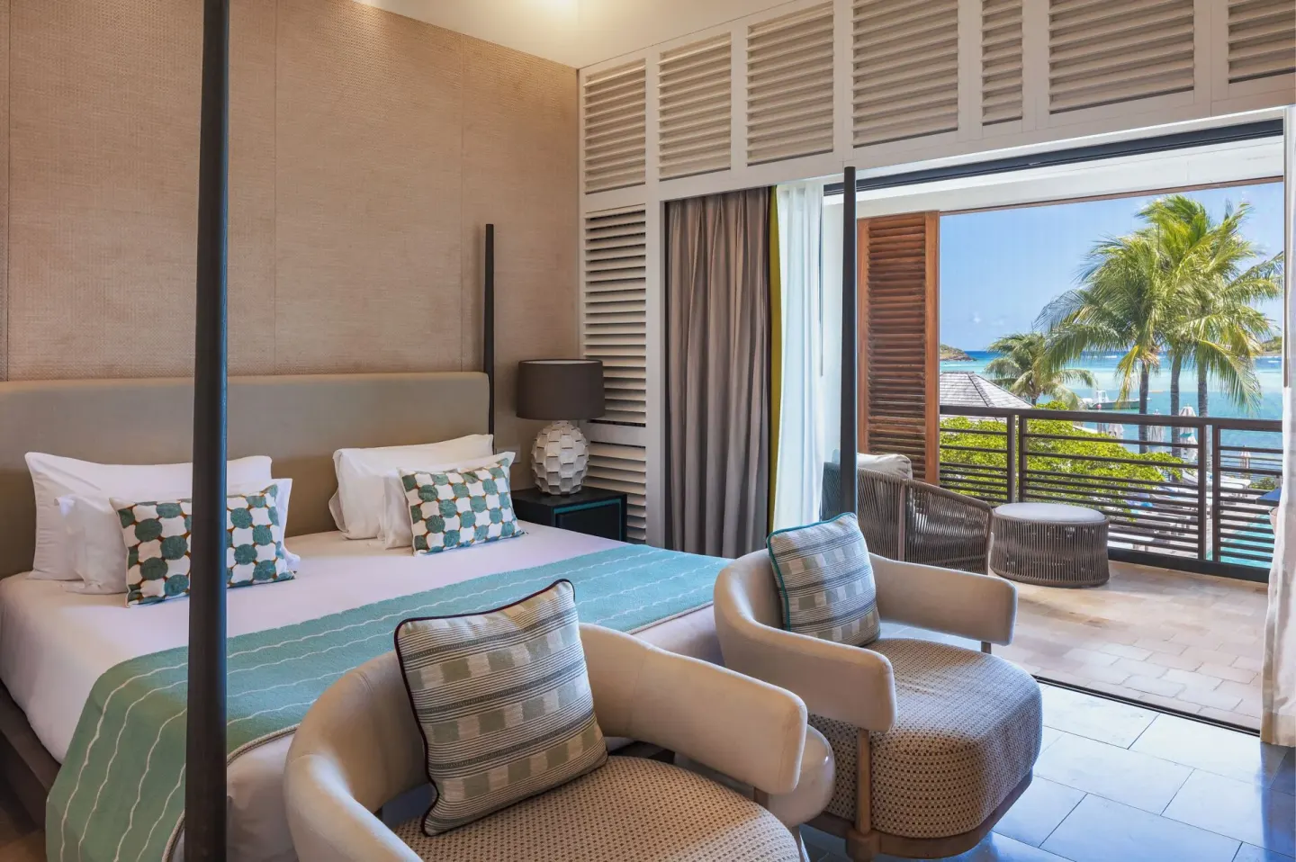 King bed and balcony sea view in Le Barth Océan Vue Mer at Le Barthélemy Hotel & Spa.