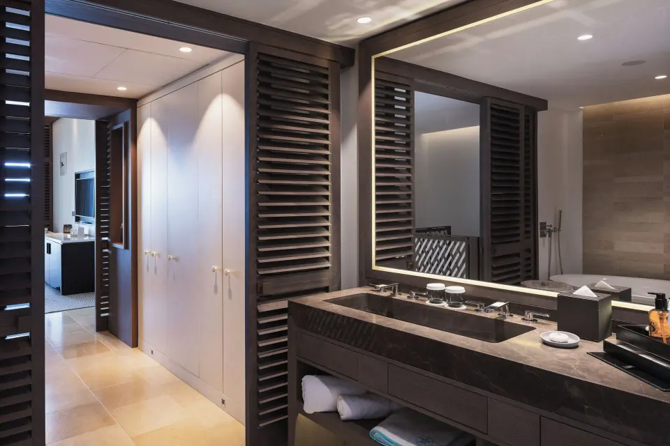 Vanity area in Le Duplex Océan Plage at Le Barthélemy Hotel & Spa with mirror, sink, and bath amenities.