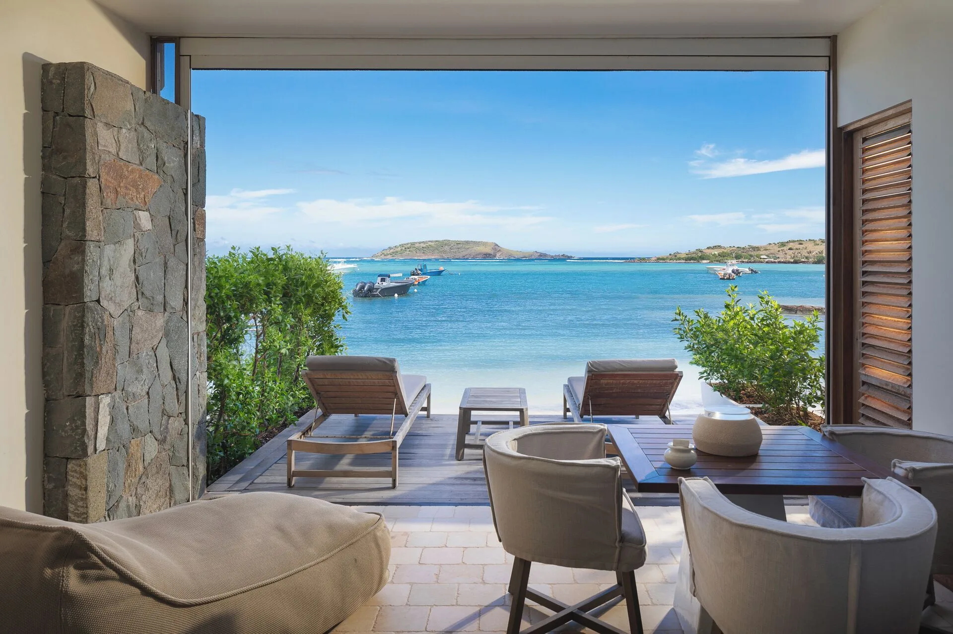 La Suite Barthélemy Plage beachfront terrace with loungers at Le Barthélemy Hotel & Spa on St. Barth's Grand Cul-de-Sac.