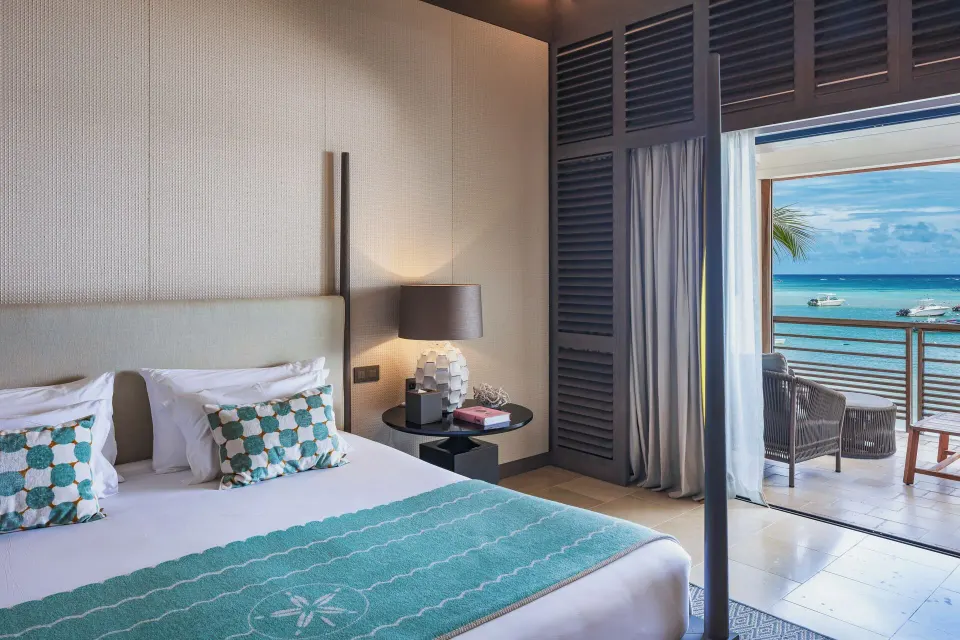 Ocean-facing bedroom in Le Duplex Océan Plage at Le Barthélemy Hotel & Spa with balcony seating.