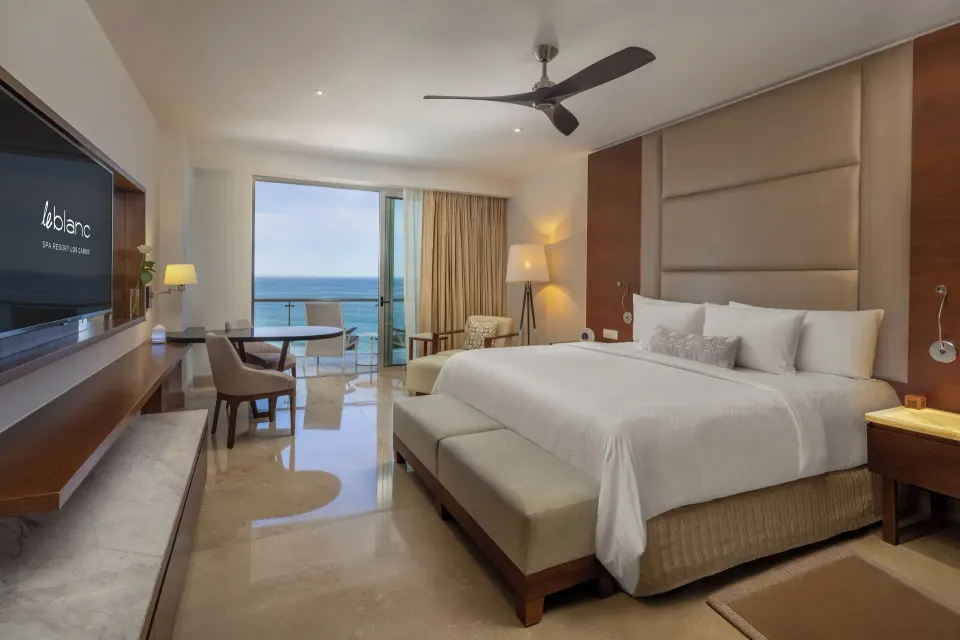 Royale Honeymoon Ocean View king room at Le Blanc Spa Resort Los Cabos with bed and open balcony.