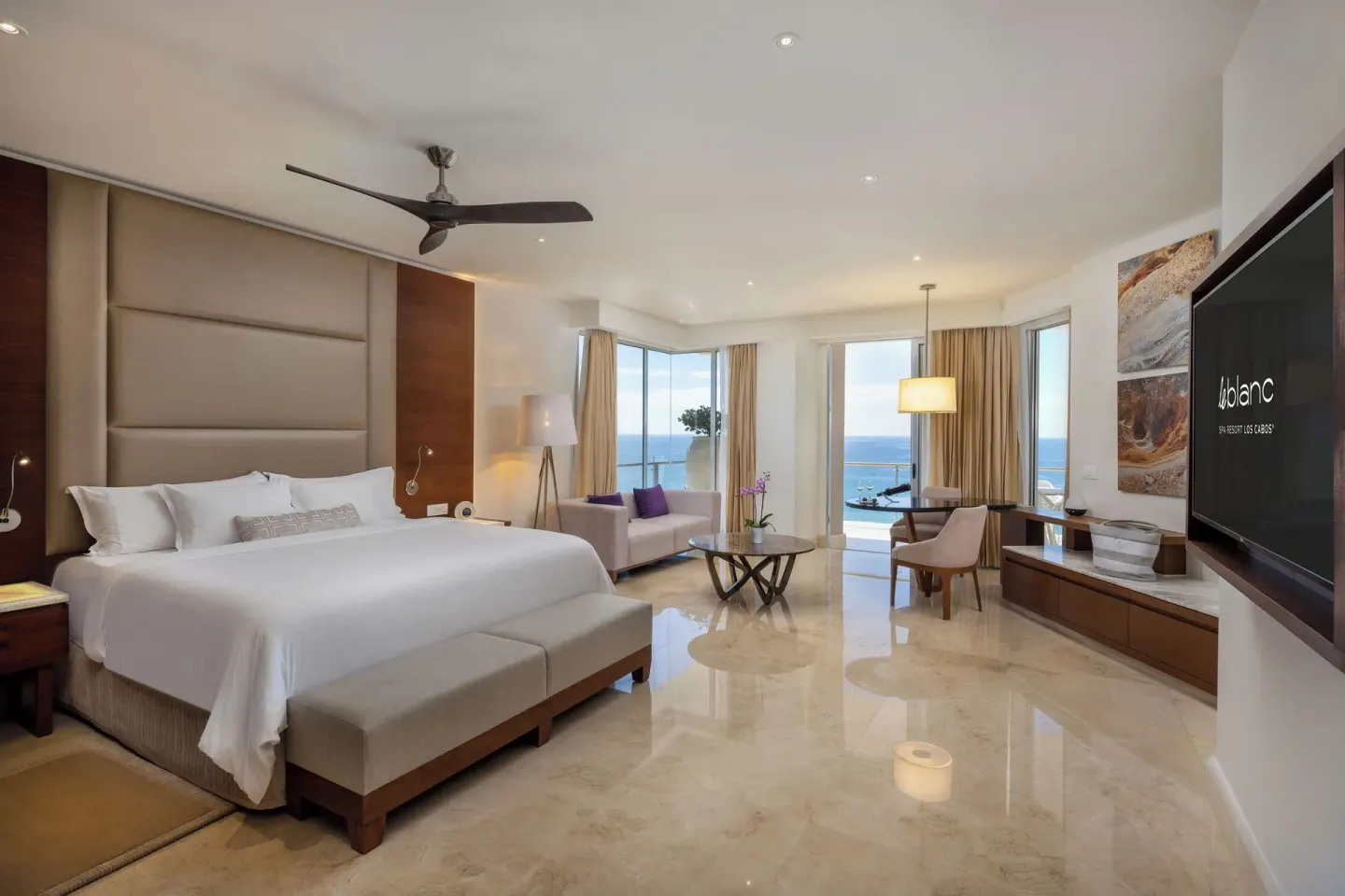 Royale Junior Suite Ocean View king bed and sitting area at Le Blanc Spa Resort Los Cabos.