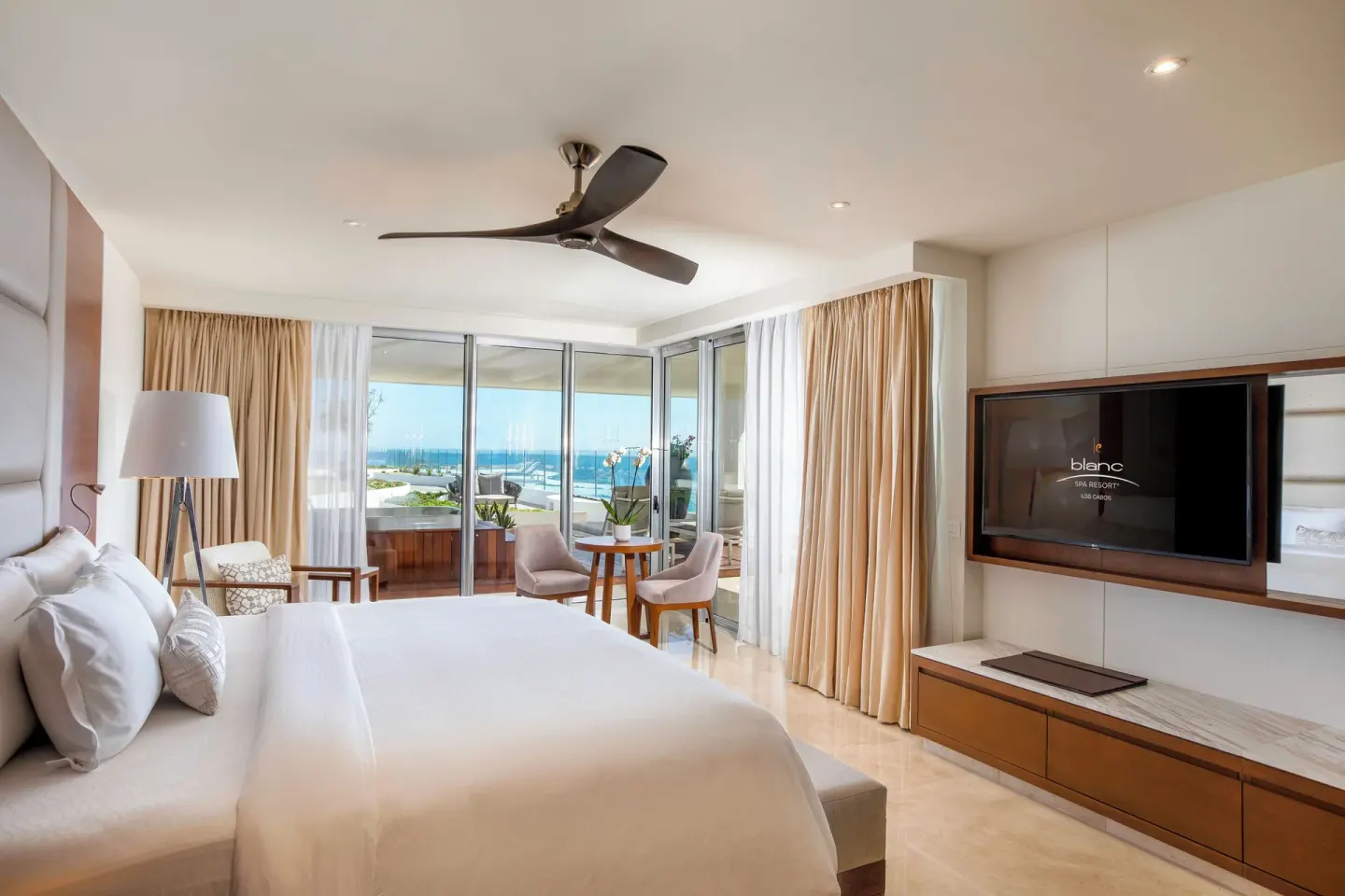Royale Three Bedrooms Villa king bedroom with ocean-facing terrace at Le Blanc Spa Resort Los Cabos.