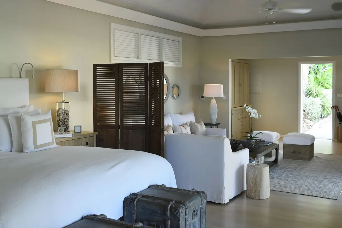 Guest suite with king bed and separate sitting area at Le Toiny Hôtel & Beach Club.