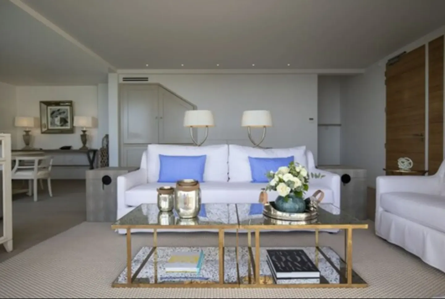 White sofa seating area with glass coffee table at Le Toiny Hôtel & Beach Club.