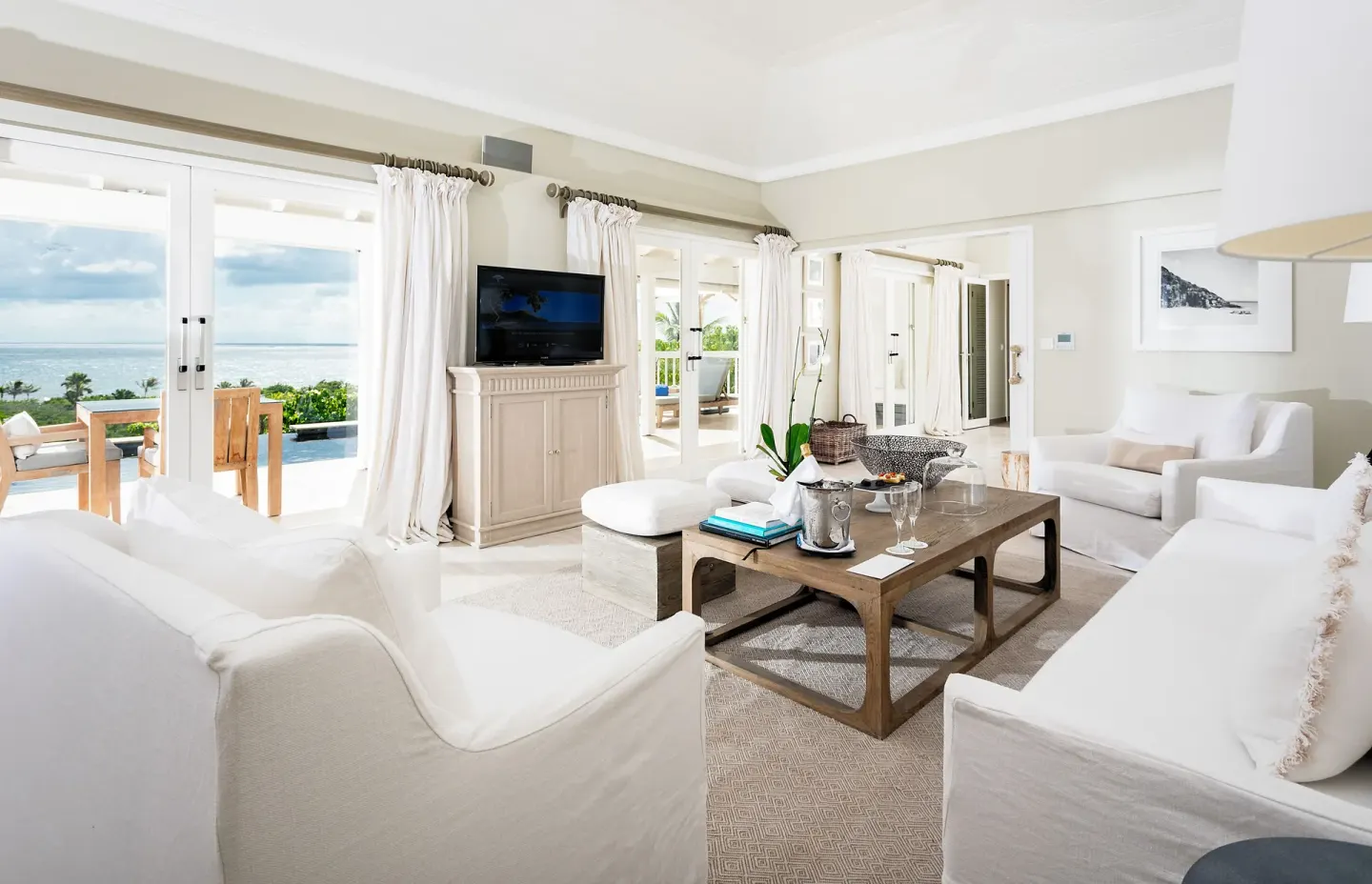 Ocean-facing villa living room with white sofas at Le Toiny Hôtel & Beach Club.