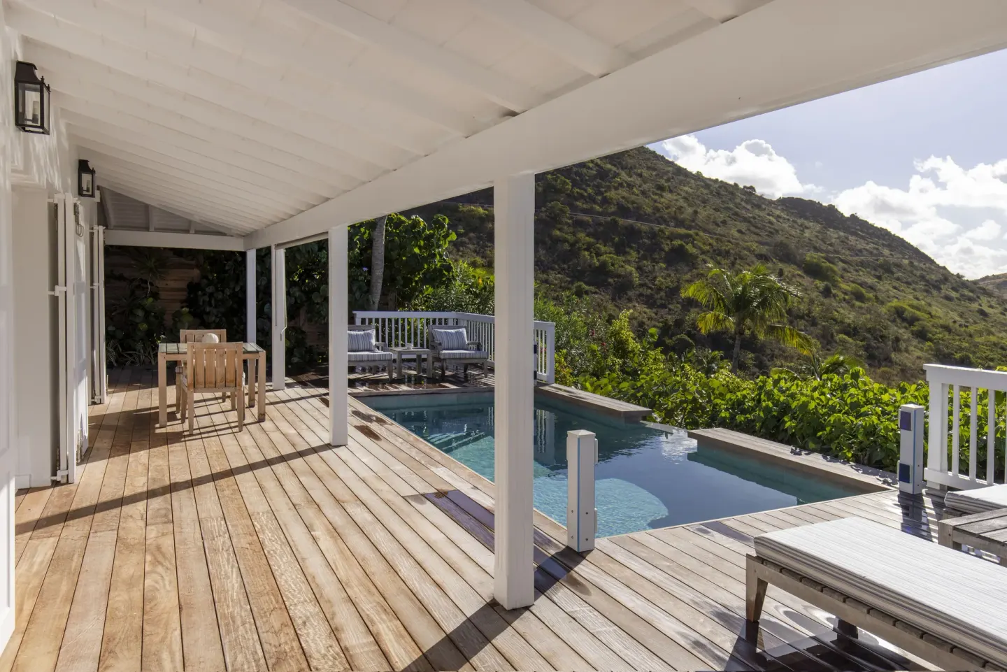 Covered wooden deck with private pool and hillside view at Le Toiny Hôtel & Beach Club.
