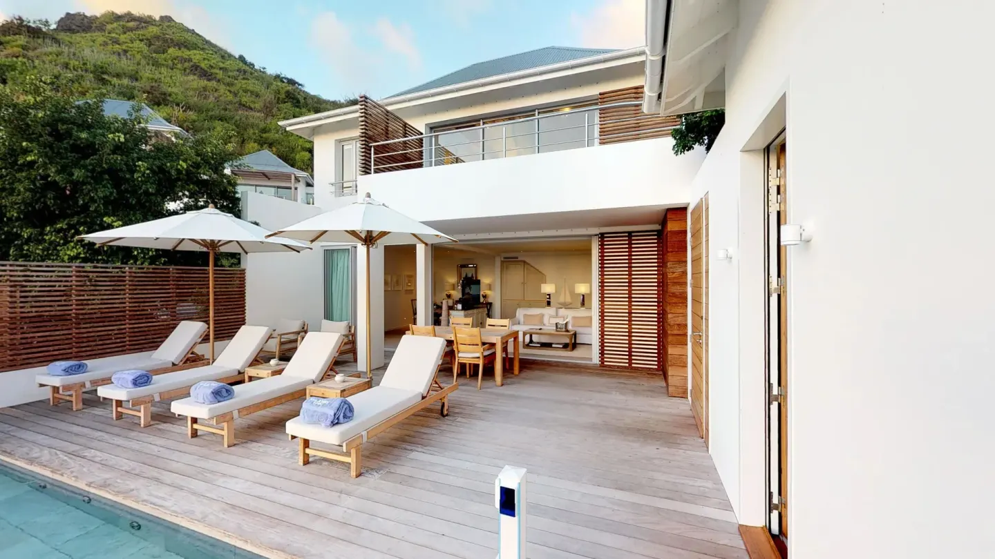 Private villa terrace with pool, loungers and open living area at Le Toiny Hôtel & Beach Club.