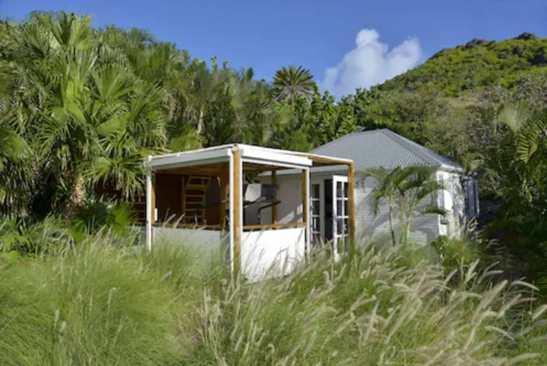 White villa surrounded by tropical greenery at Le Toiny Hôtel & Beach Club.