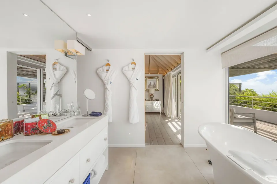 Duplex Spirit Suite bathroom with tub and terrace view at Le Toiny Hôtel & Beach Club.