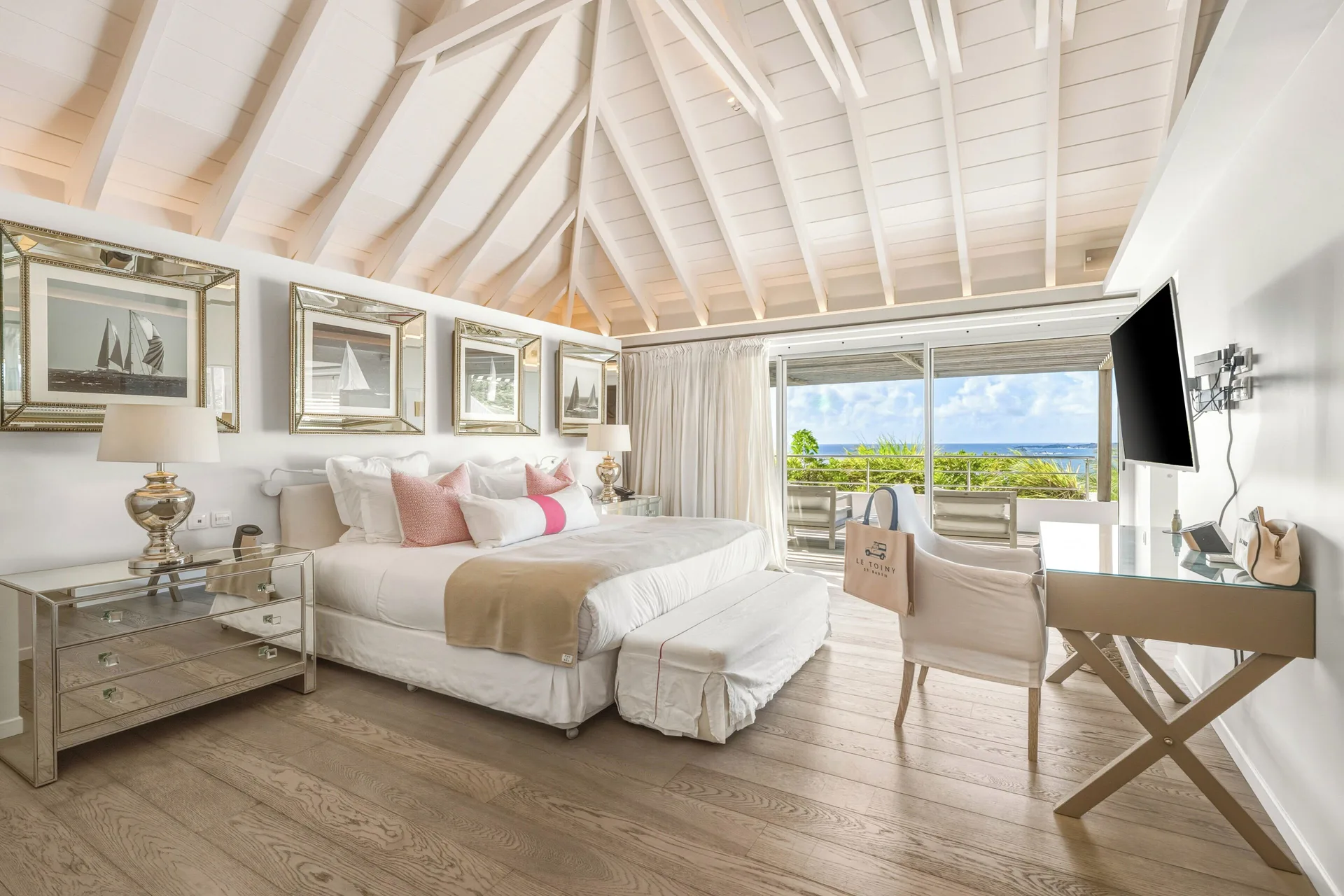 Duplex Spirit Suite king bed with balcony ocean view at Le Toiny Hôtel & Beach Club.