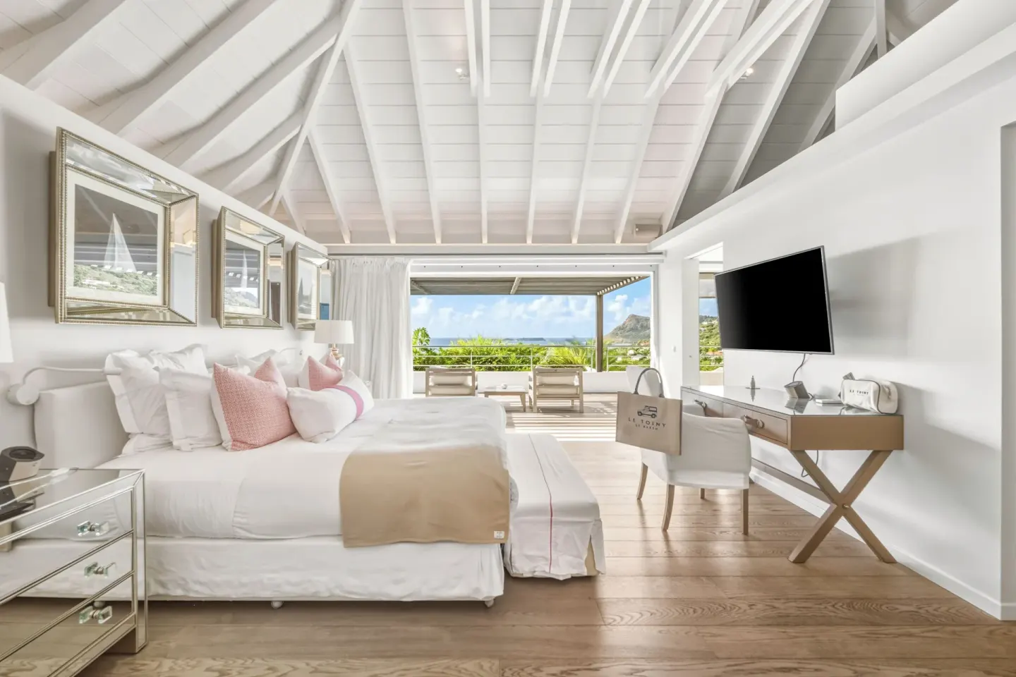Duplex Spirit Suite king bed and terrace view at Le Toiny Hôtel & Beach Club.