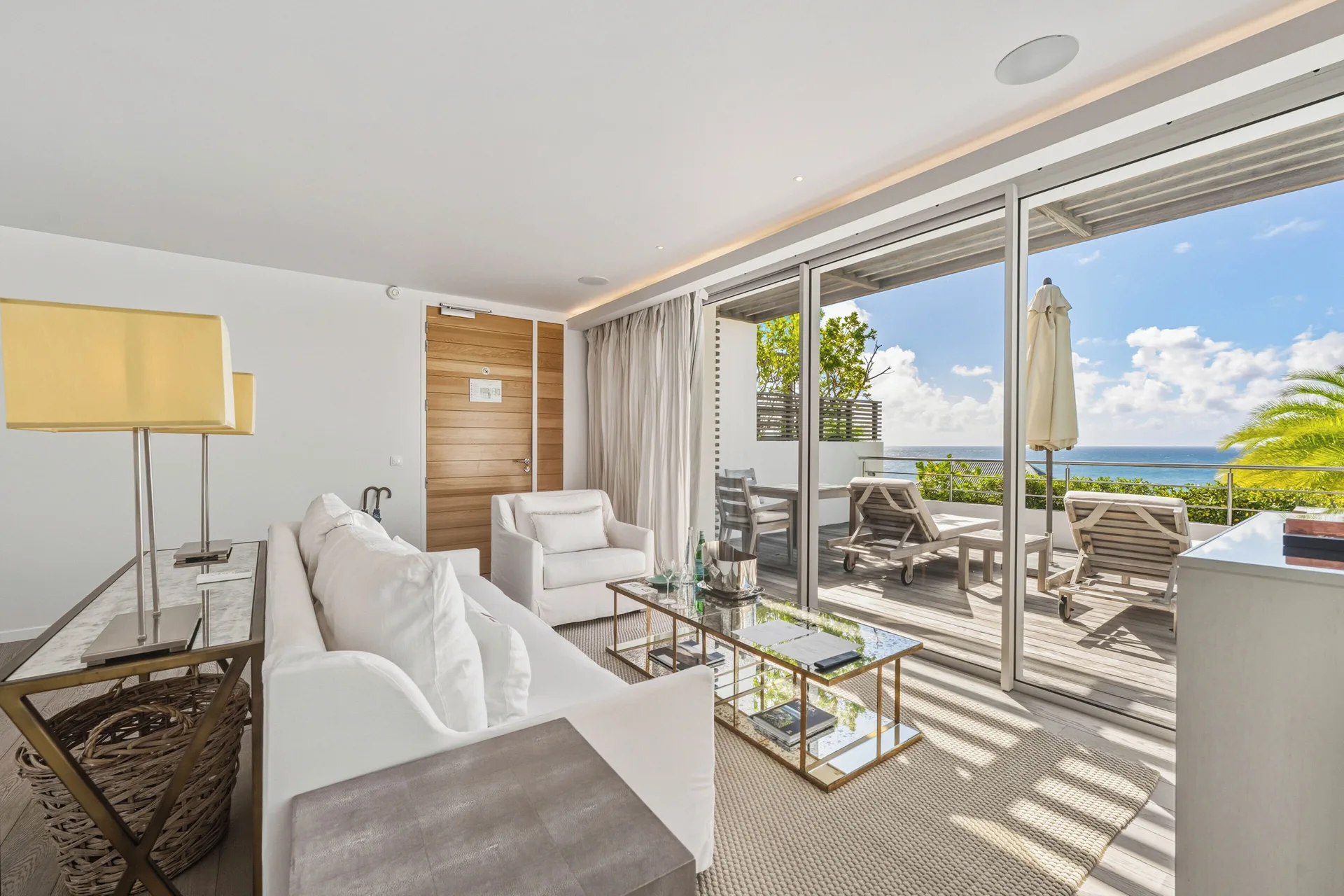 Duplex Spirit Suite lounge opening to ocean-view deck at Le Toiny Hôtel & Beach Club.