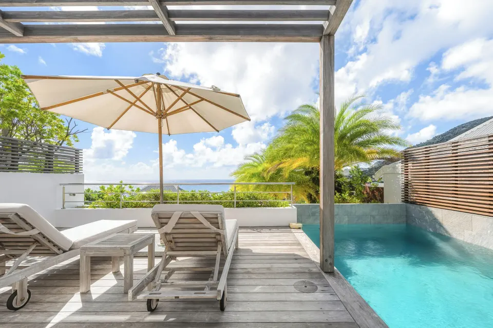 Private pool terrace with umbrella and sea view at Le Toiny Hôtel & Beach Club.