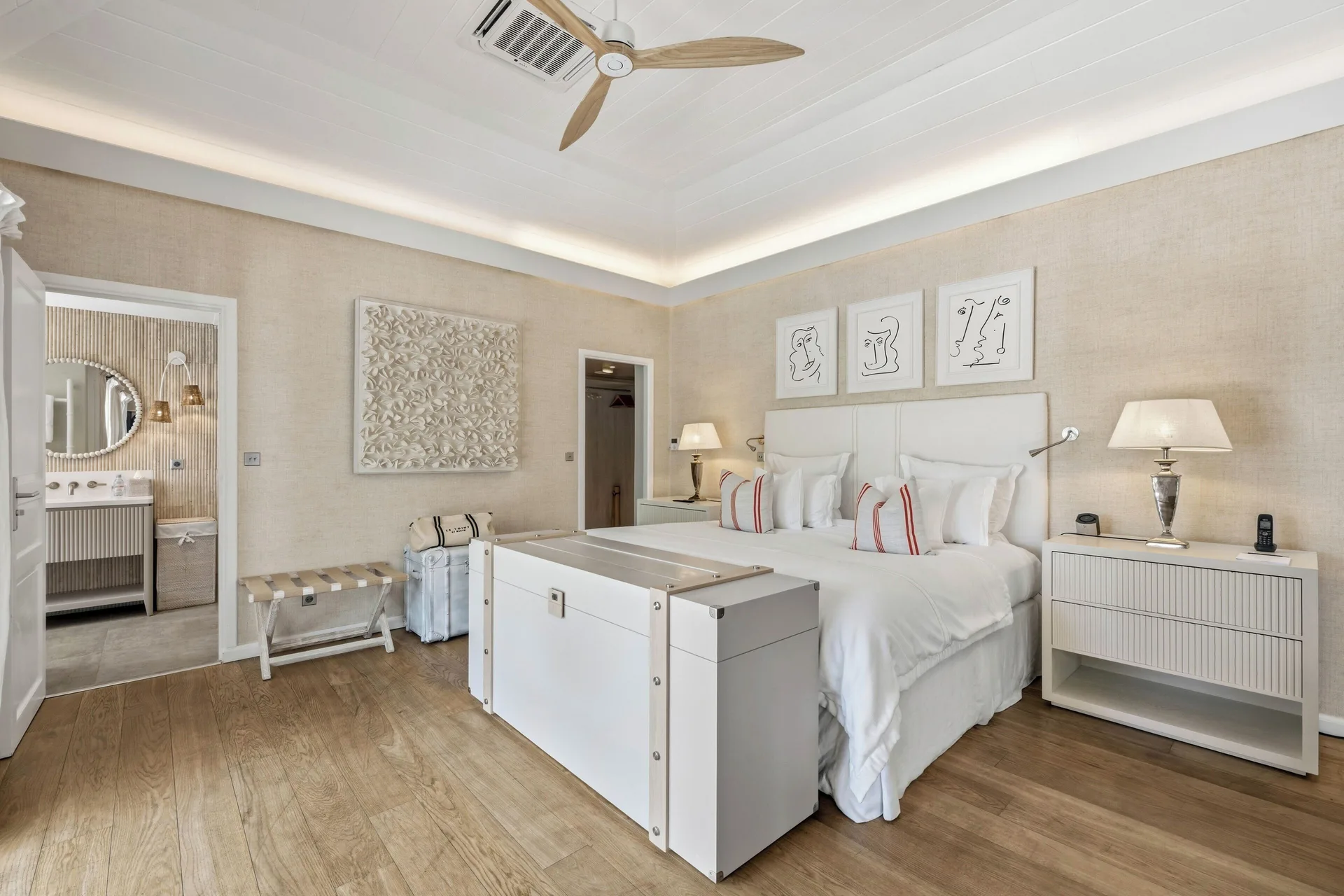 Junior Suite king bed with bathroom doorway at Le Toiny Hôtel & Beach Club.