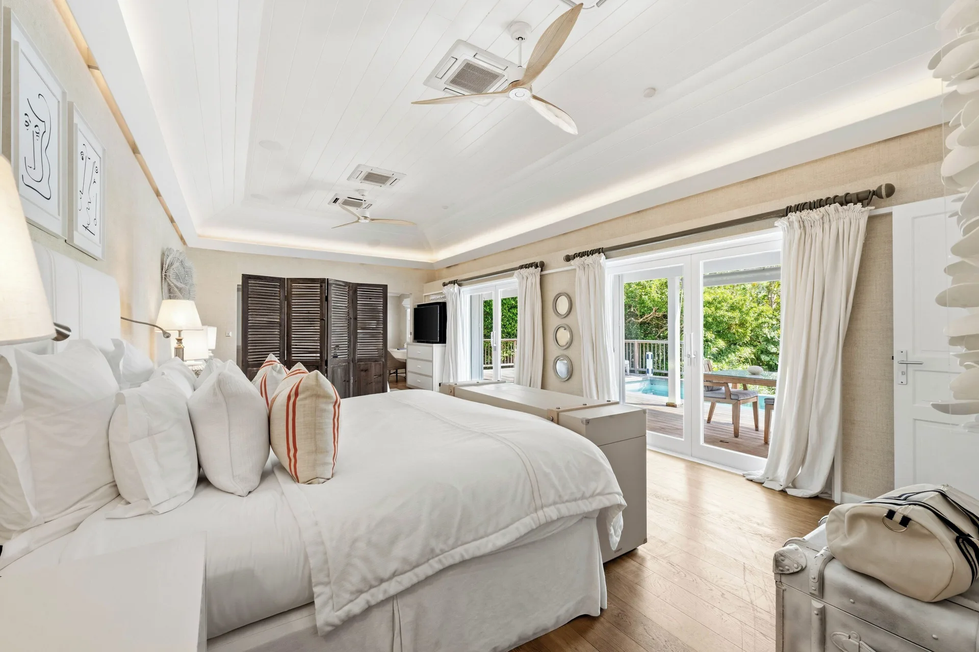 Junior Suite king bed opening to a pool terrace at Le Toiny Hôtel & Beach Club.