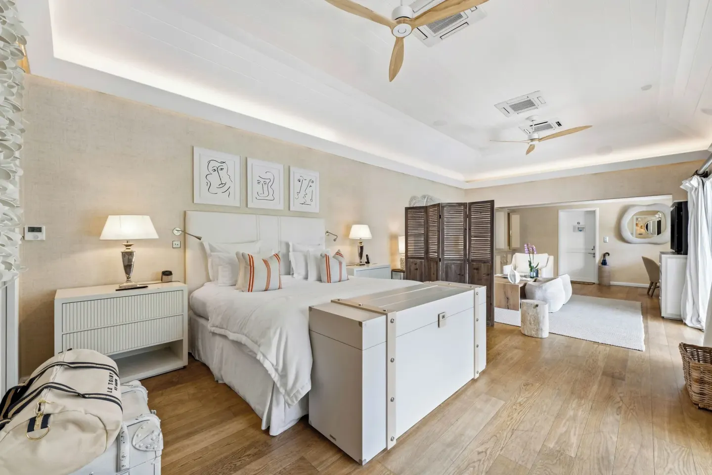 Junior Suite bedroom with king bed and seating area at Le Toiny Hôtel & Beach Club.