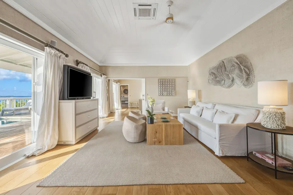 Ocean-view living room in a Signature Family Suite at Le Toiny Hôtel & Beach Club with terrace and pool beyond.