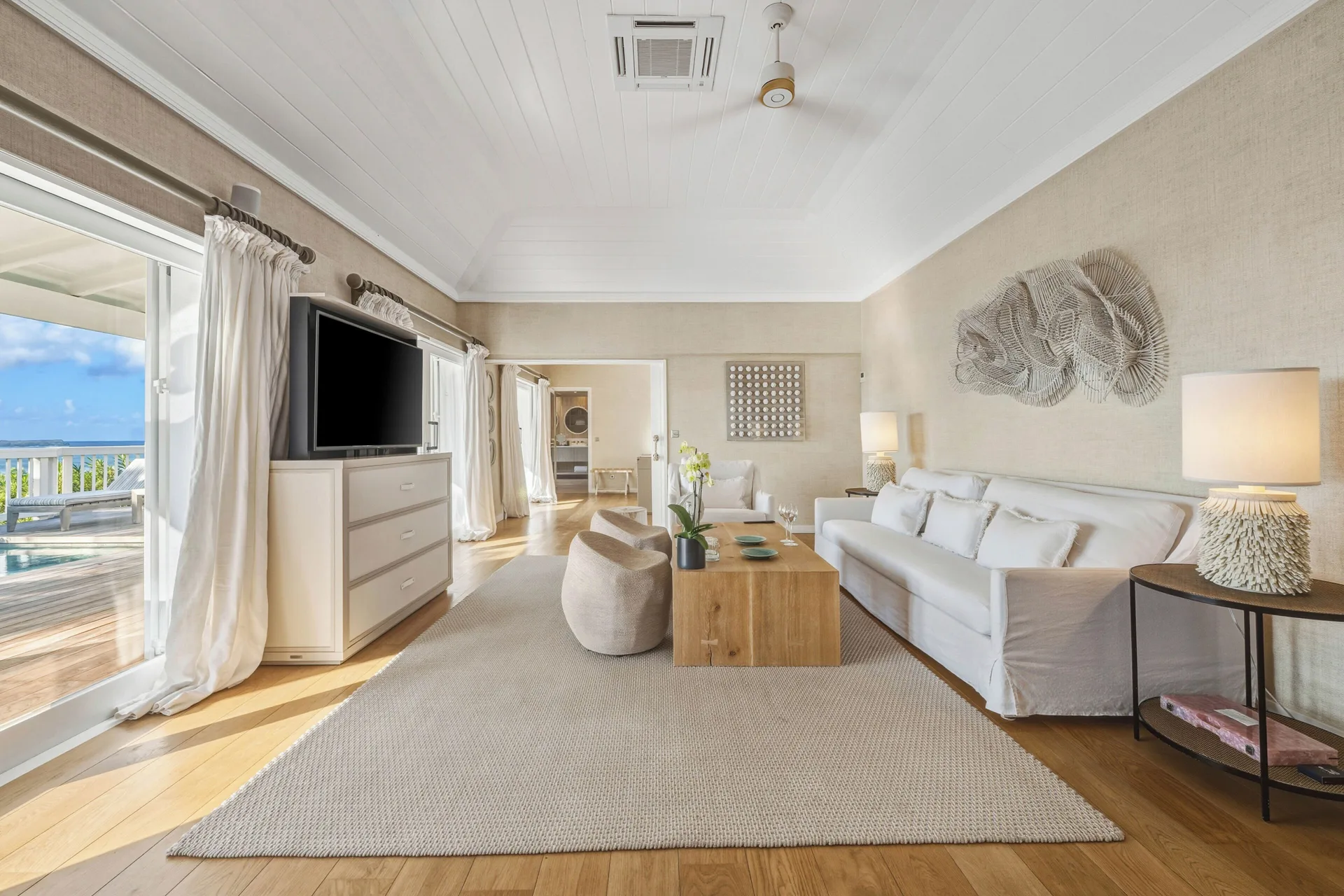 Ocean-view living room in a Signature Family Suite at Le Toiny Hôtel & Beach Club with terrace and pool beyond.